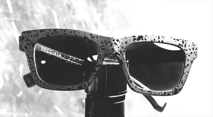 Two pairs of sculptural eyewear resting on a pale surface