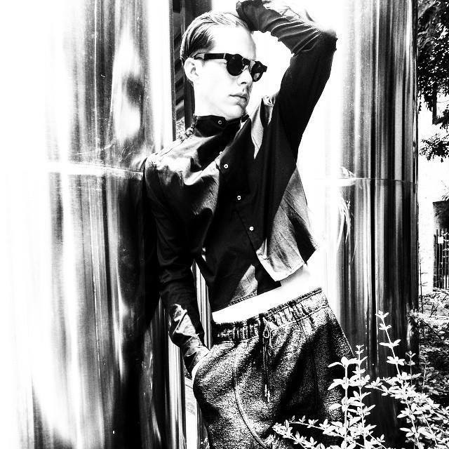 Black and white portrait of a model wearing angular sunglasses
